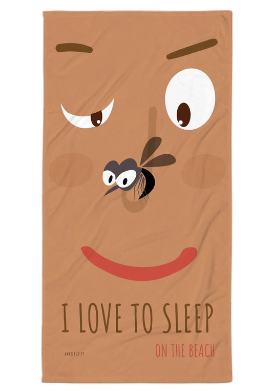 Beach towel with cartoon face and text 'I love to sleep on the beach' on a brown background
